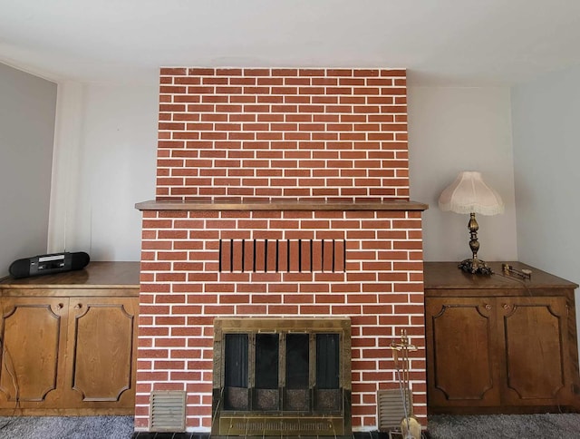 details with a fireplace and carpet