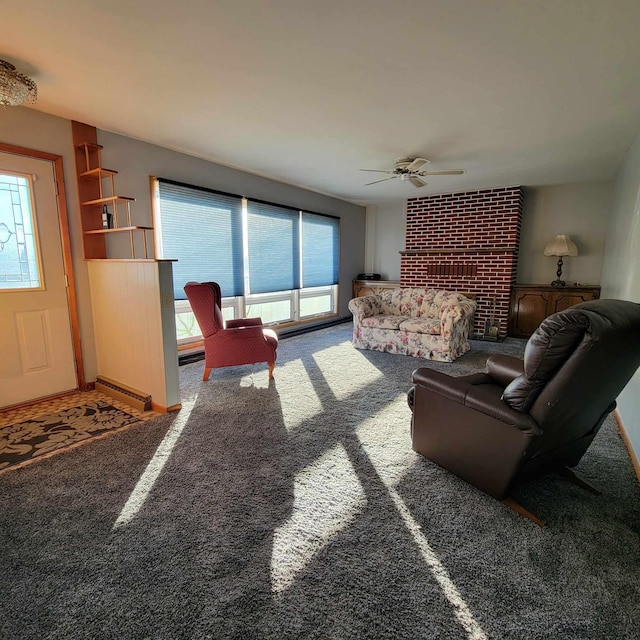 carpeted living room with ceiling fan, a fireplace, and a baseboard radiator