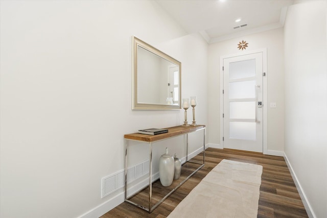 entryway featuring ornamental molding and dark wood-type flooring