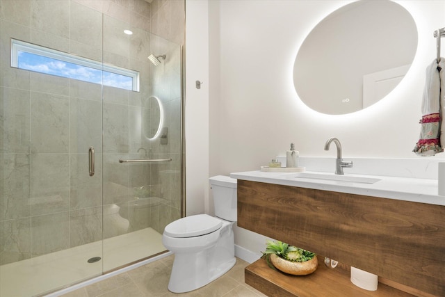 bathroom featuring tile patterned floors, vanity, toilet, and a shower with shower door