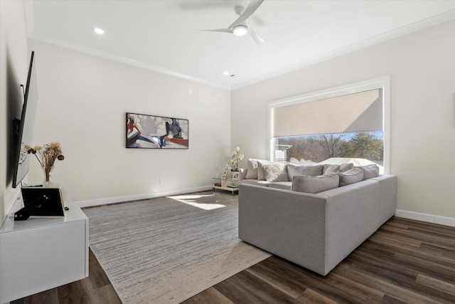 living room featuring dark hardwood / wood-style flooring, ceiling fan, and ornamental molding