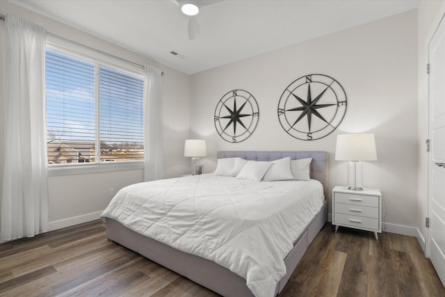 bedroom with dark hardwood / wood-style floors