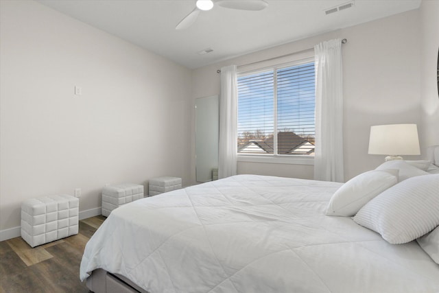 bedroom with ceiling fan and dark hardwood / wood-style flooring