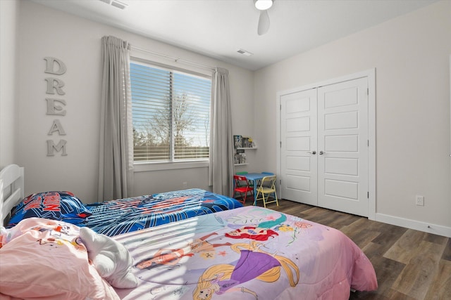 bedroom with dark hardwood / wood-style floors and a closet