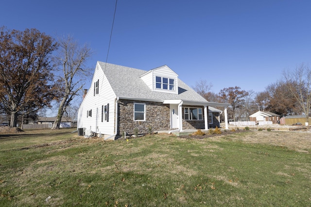 cape cod house with a front lawn