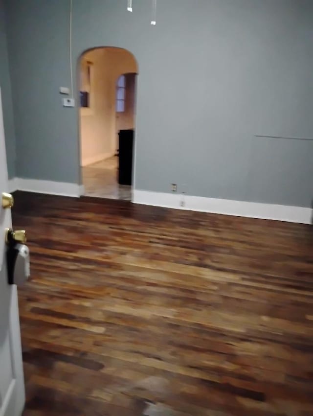 empty room with dark wood-type flooring