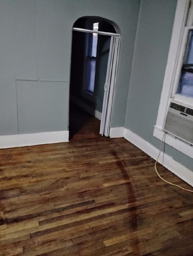 unfurnished room with dark hardwood / wood-style flooring