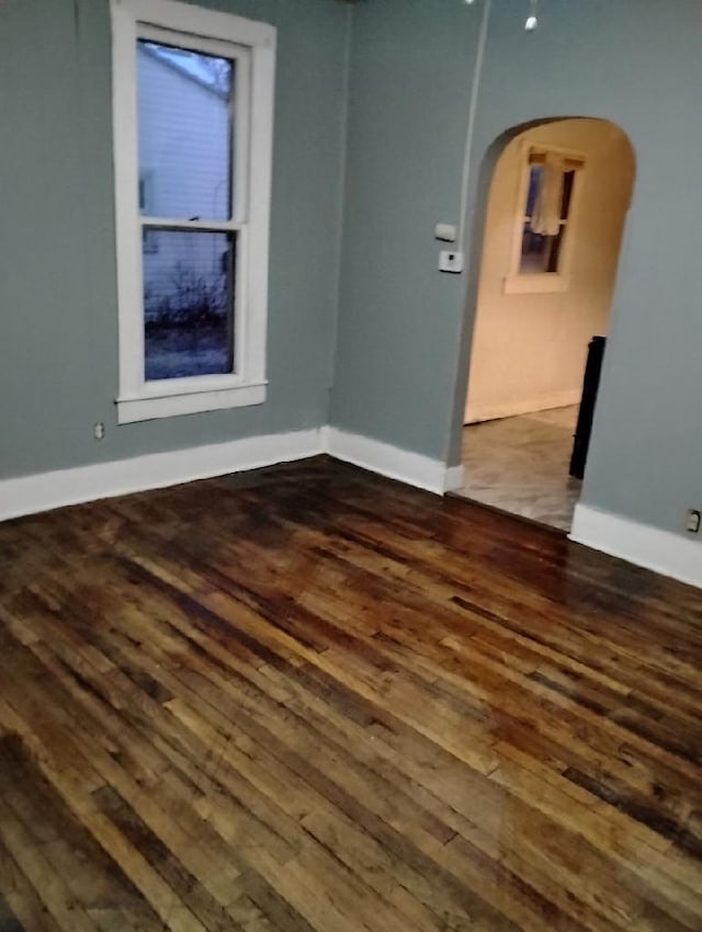 unfurnished room featuring dark wood-type flooring