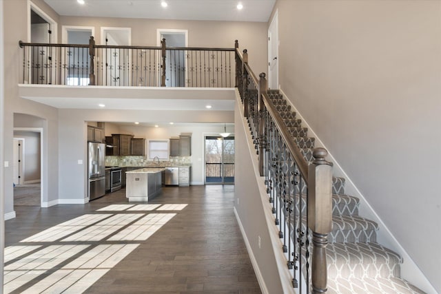 stairs with hardwood / wood-style flooring and sink