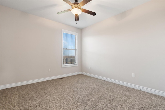 spare room featuring carpet flooring and ceiling fan