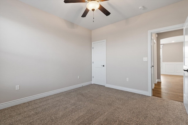 carpeted spare room with ceiling fan