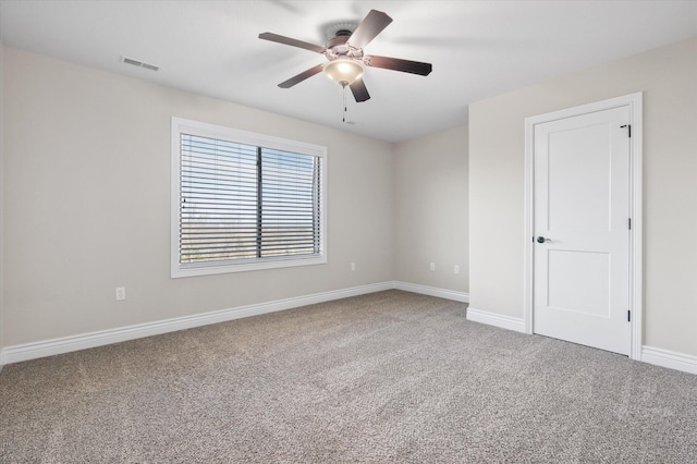 carpeted spare room with ceiling fan