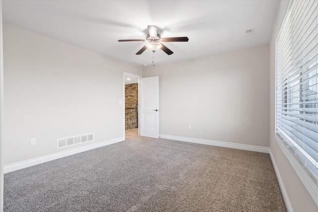 carpeted empty room with ceiling fan