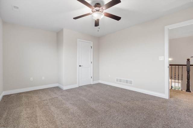 carpeted spare room with ceiling fan