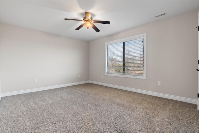 unfurnished room featuring ceiling fan and carpet