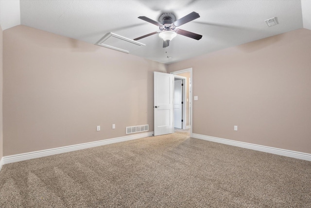 carpeted spare room featuring ceiling fan and lofted ceiling