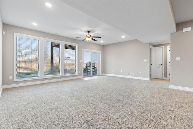 unfurnished living room featuring light carpet, plenty of natural light, and ceiling fan