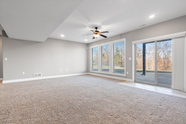 unfurnished living room featuring ceiling fan, plenty of natural light, and carpet