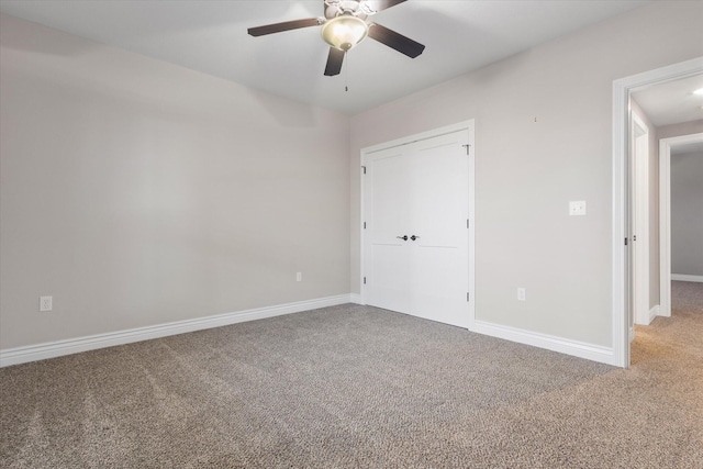 unfurnished bedroom with carpet, ceiling fan, and a closet