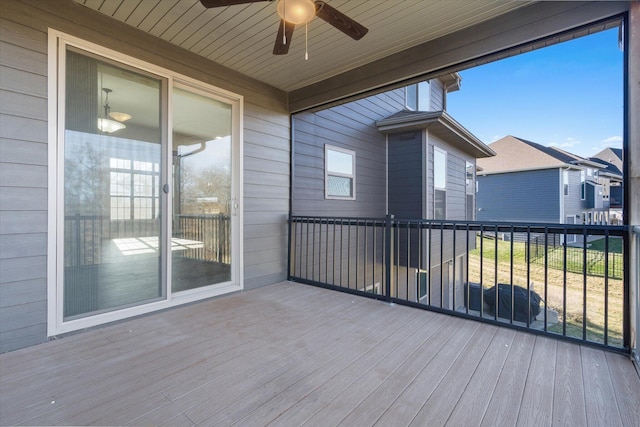 unfurnished sunroom with ceiling fan