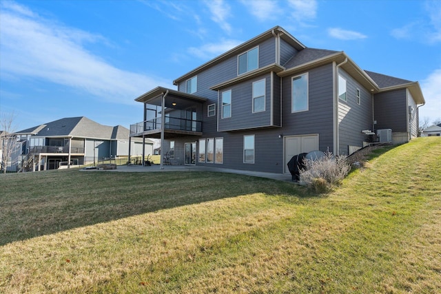 back of property featuring a lawn, cooling unit, a balcony, and a patio