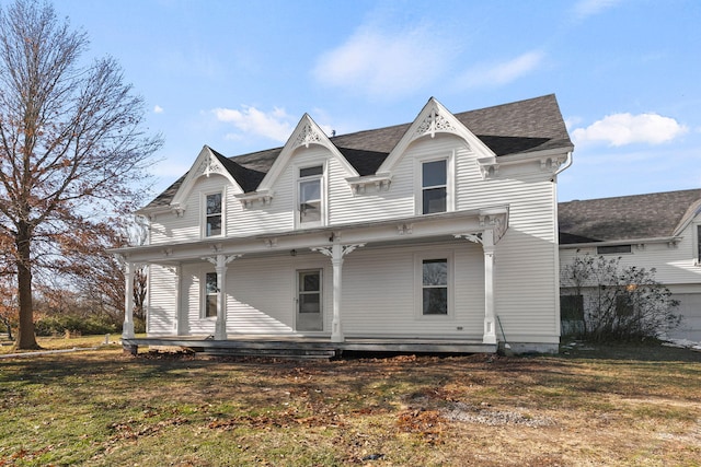 back of house featuring a lawn and a porch