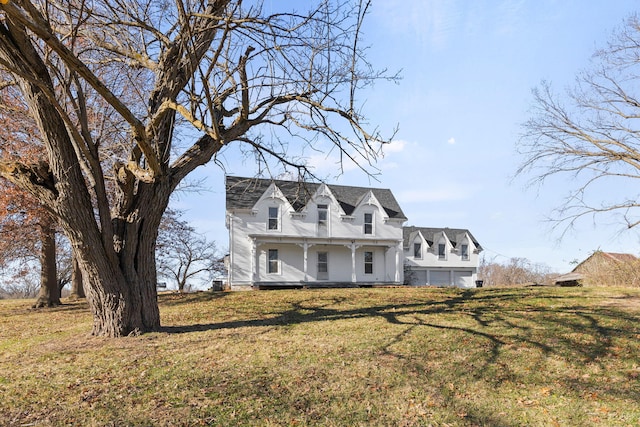 cape cod home with a front yard