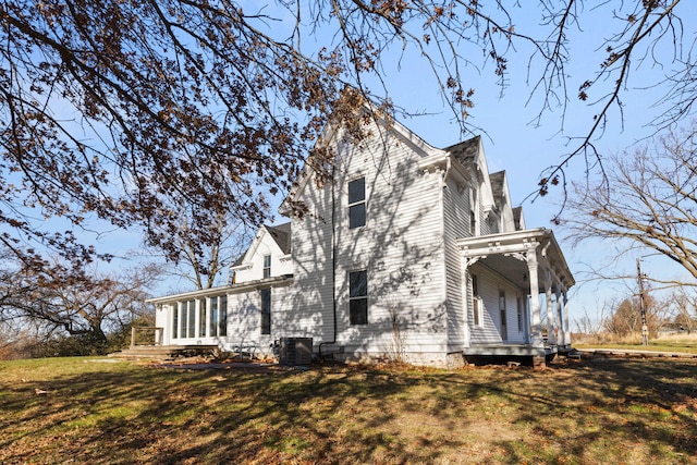 view of home's exterior featuring a lawn and central AC unit