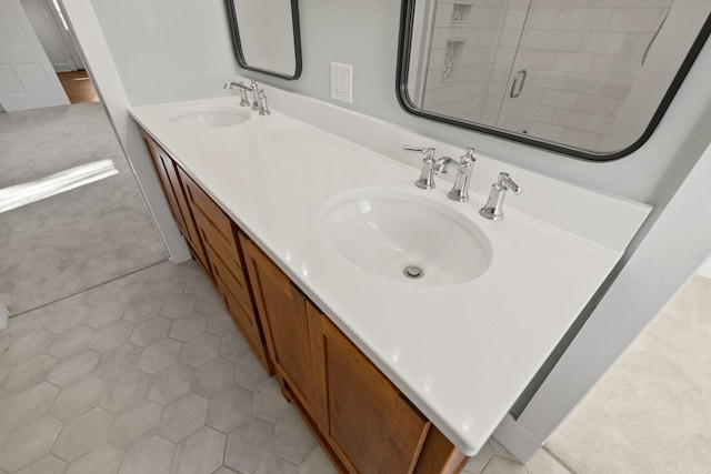 bathroom with a tile shower, tile patterned floors, and vanity