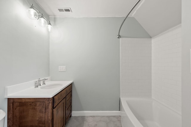 bathroom with vanity and tiled shower / bath combo