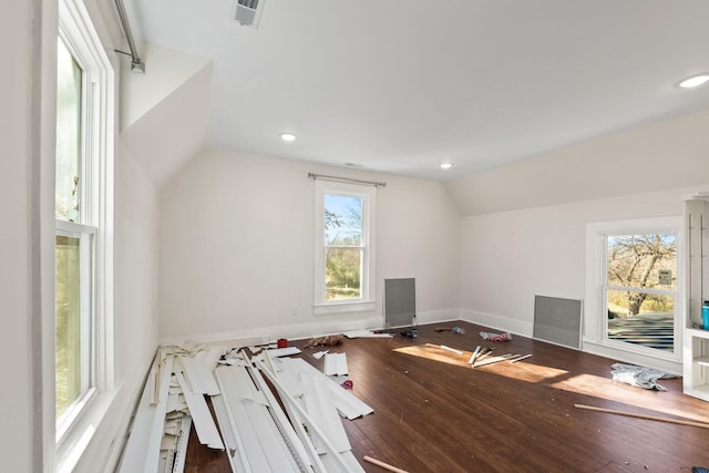 additional living space with hardwood / wood-style flooring and vaulted ceiling