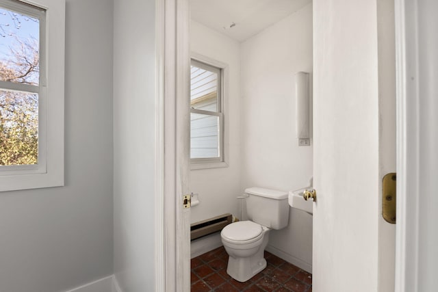 bathroom with toilet and a baseboard heating unit