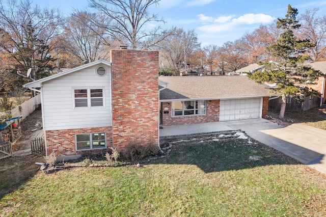 tri-level home with a front yard and a garage