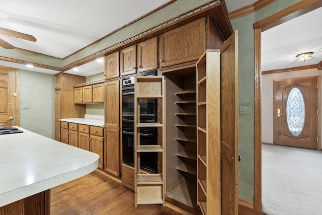 kitchen with wood-type flooring and ornamental molding