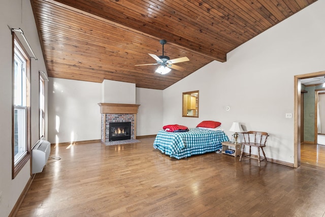 bedroom with hardwood / wood-style floors, wooden ceiling, lofted ceiling, and multiple windows