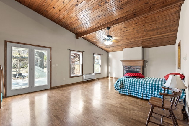 unfurnished bedroom with multiple windows, ceiling fan, hardwood / wood-style floors, and access to exterior