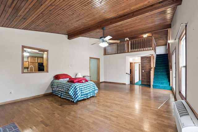 bedroom featuring hardwood / wood-style floors, ceiling fan, beam ceiling, and wood ceiling