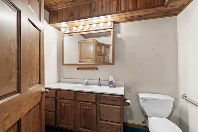 bathroom with vanity, toilet, and wood ceiling