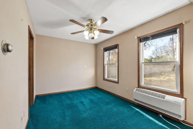 spare room featuring a wall mounted air conditioner, ceiling fan, and dark colored carpet