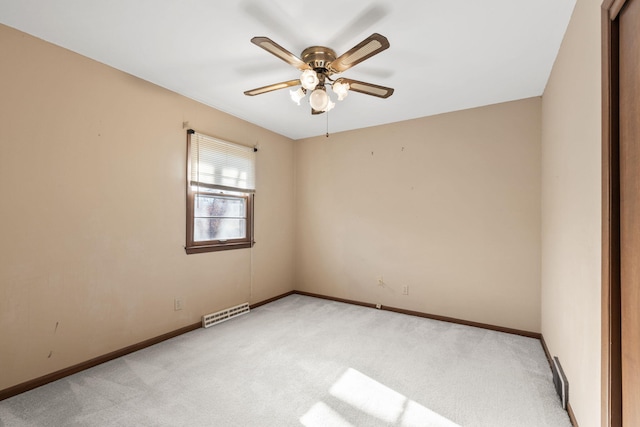 spare room with ceiling fan and light colored carpet