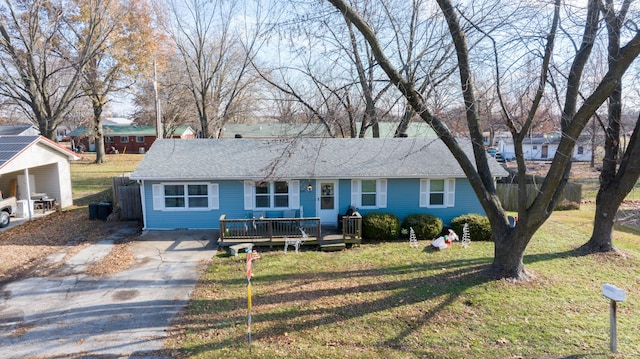 ranch-style home with a front yard and a deck