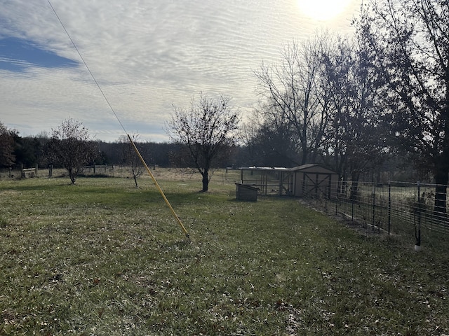 view of yard with a rural view and an outdoor structure