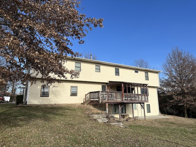 back of property featuring a yard and a deck