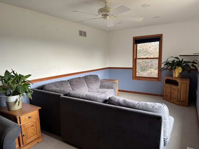 carpeted living room with ceiling fan