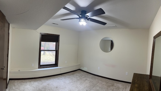 unfurnished bedroom with carpet flooring, a textured ceiling, vaulted ceiling, and ceiling fan