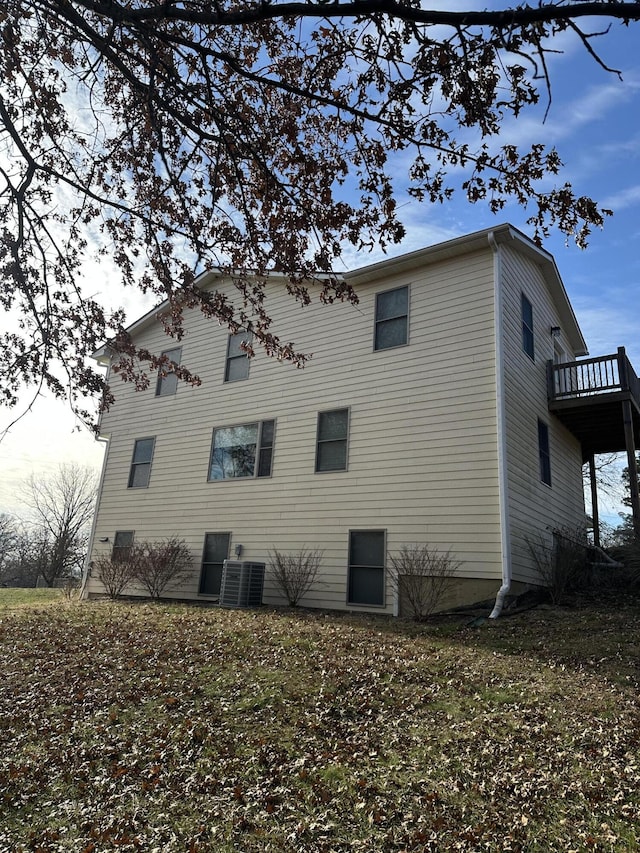 rear view of property with a balcony and central AC unit