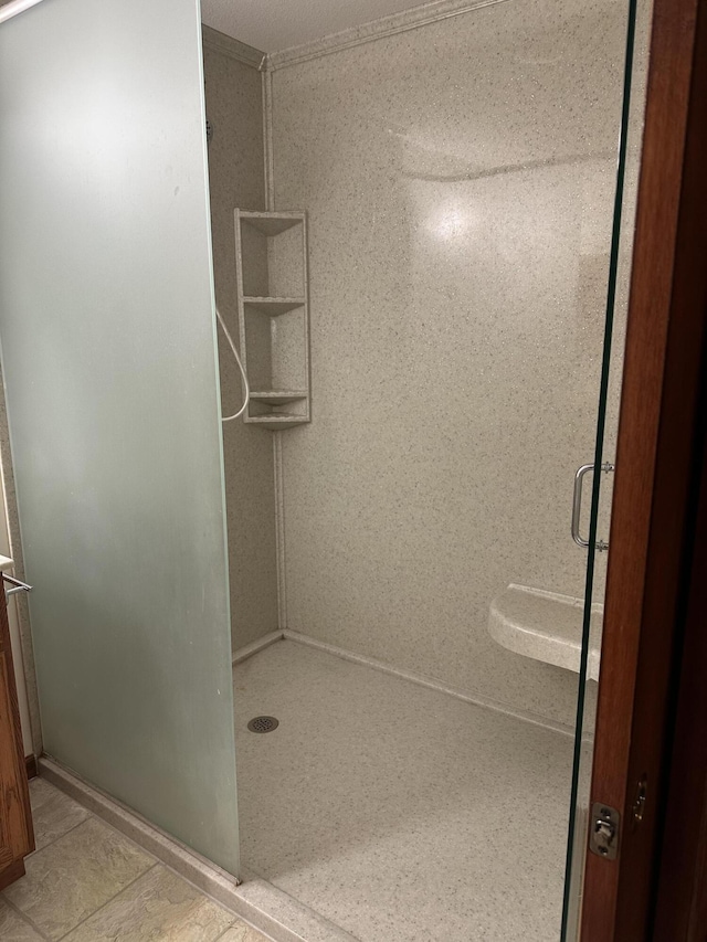 bathroom featuring tile patterned flooring and a shower with door