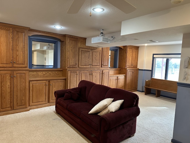 carpeted living room featuring a textured ceiling