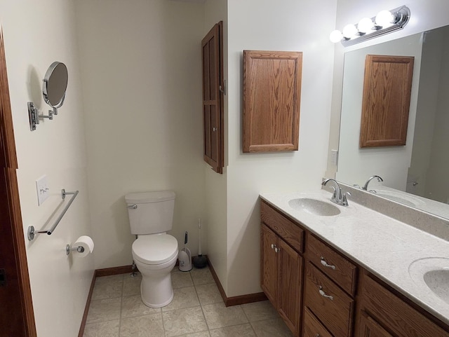 bathroom with tile patterned floors, vanity, and toilet