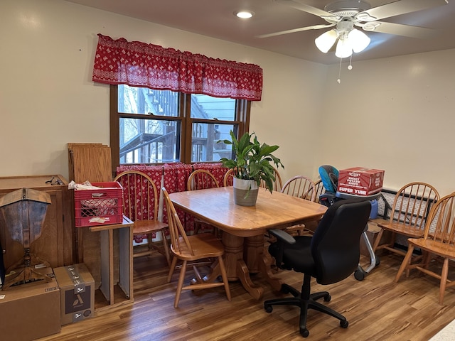 dining area featuring ceiling fan and wood-type flooring